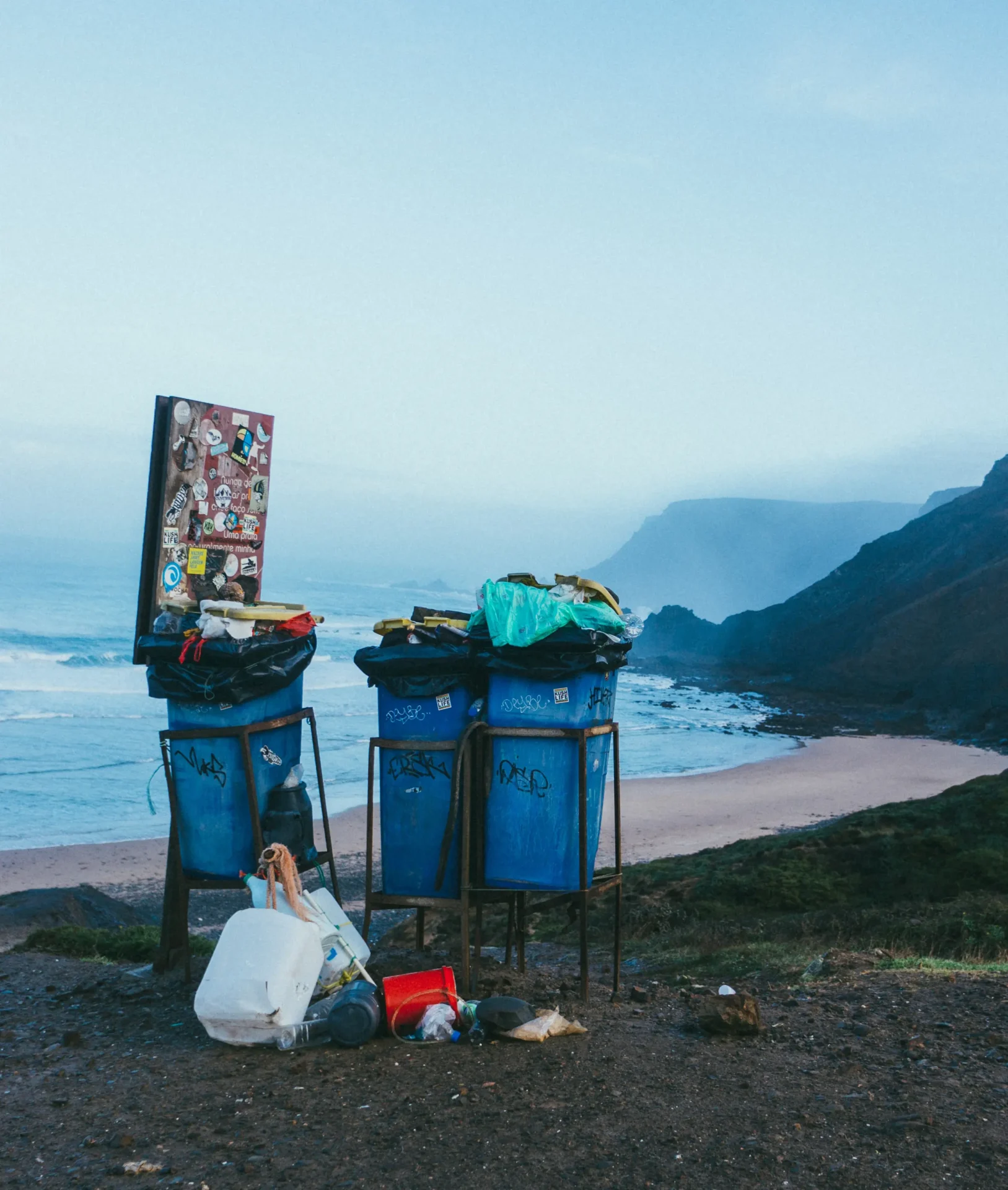 Trash bins full of junk near the shore